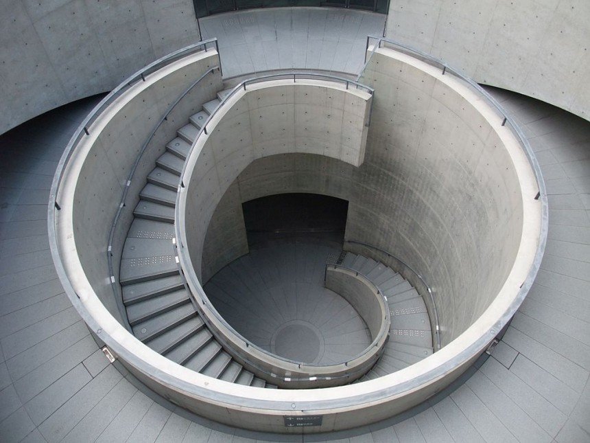 Tadao Ando designed coastal museum in Japan featuring concrete architecture and glass overlooking the sea.